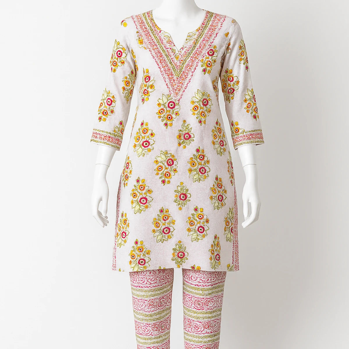 Floral embroidered dress on a mannequin against a white background