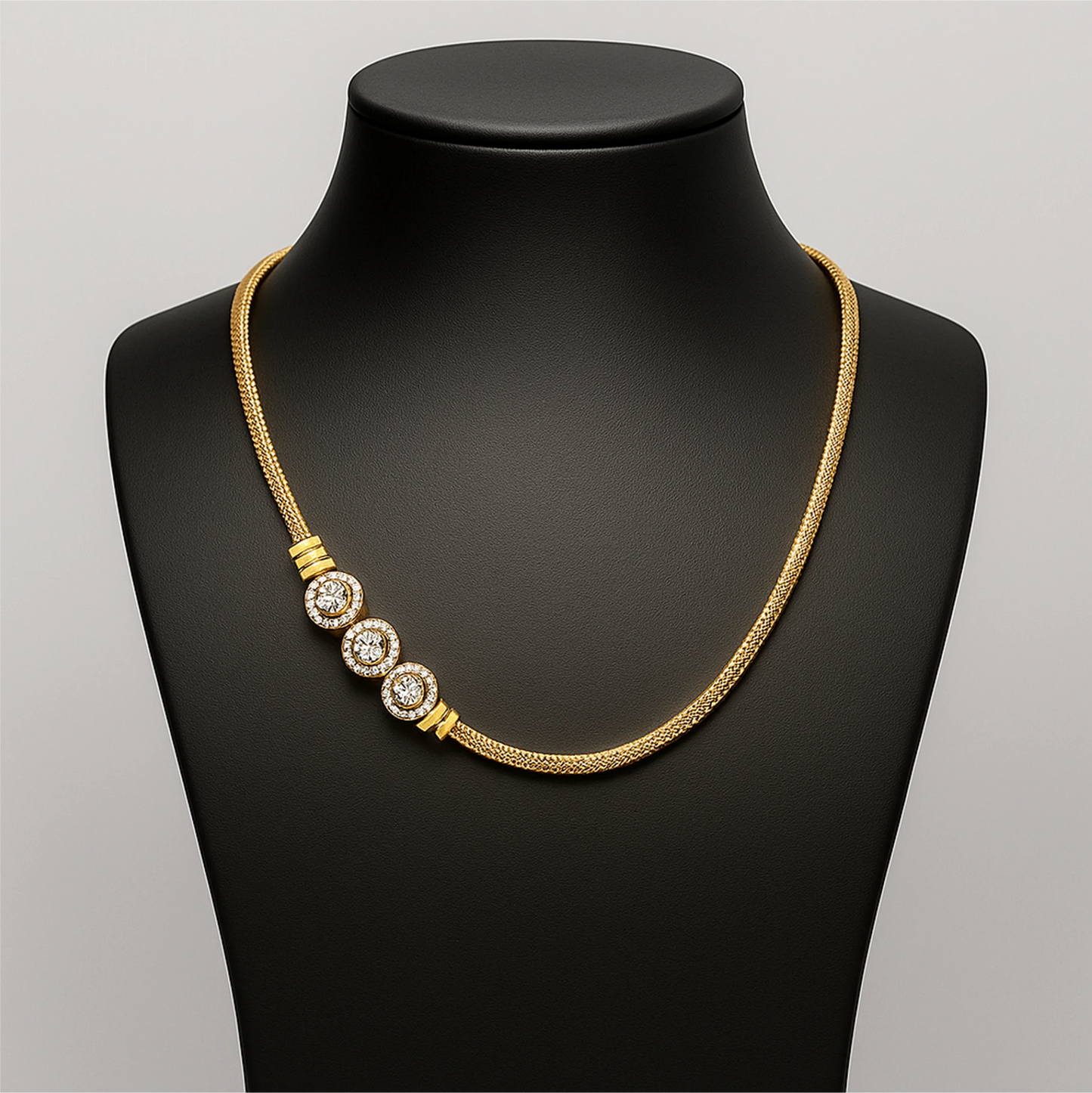 Gold necklace with three circular pendants on a black mannequin bust.