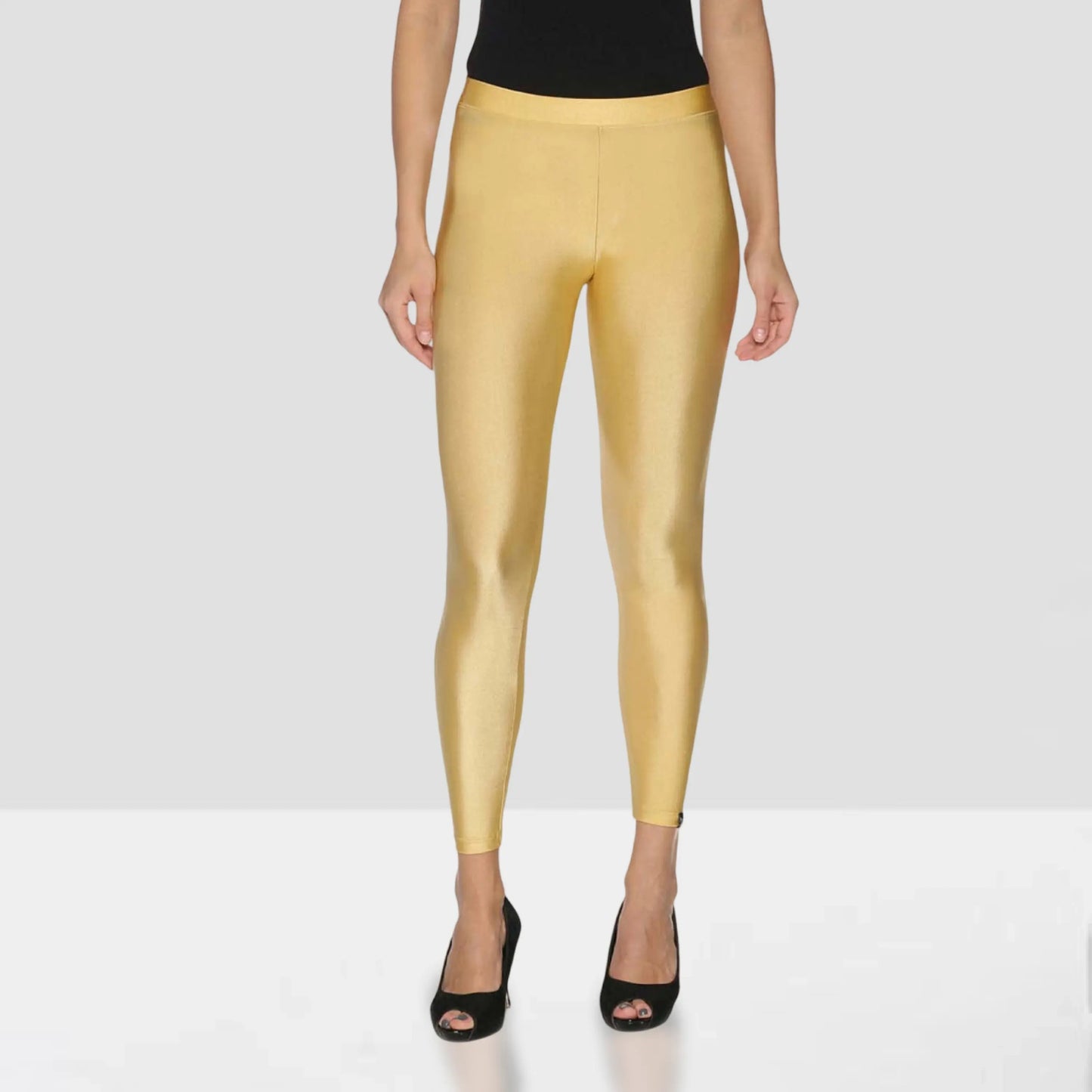 Gold leggings worn by a person on a white background