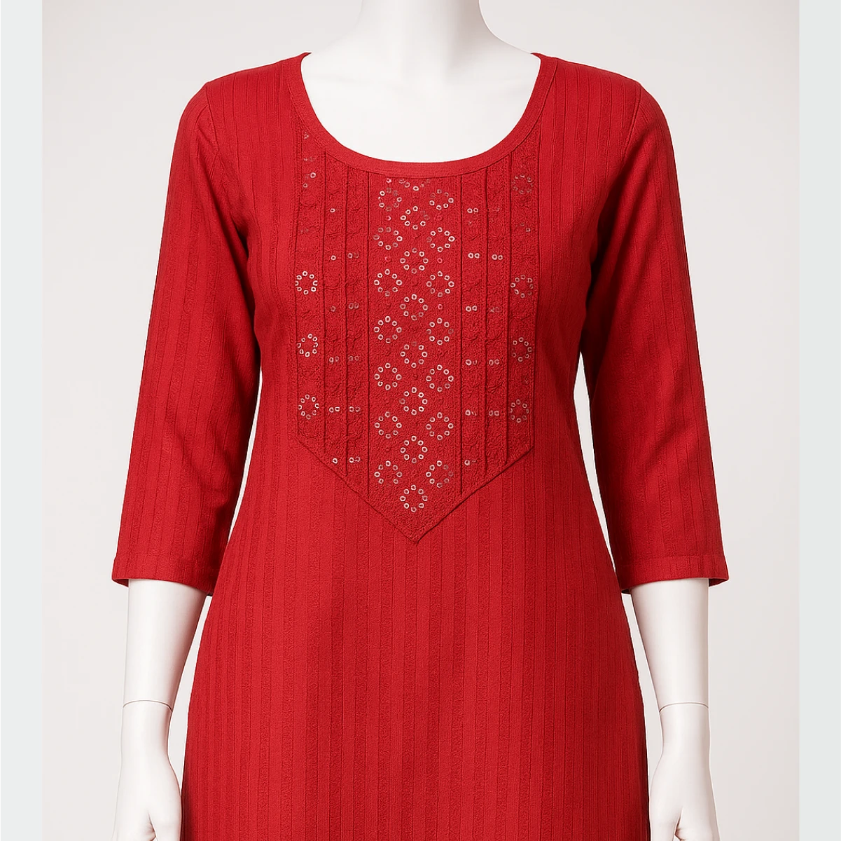 Red dress with intricate embroidery on a mannequin against a white background