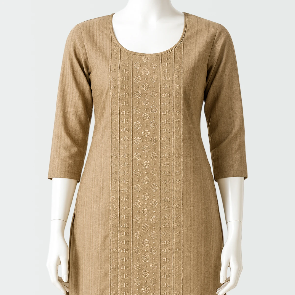 Beige dress with intricate patterns on a mannequin against a white background