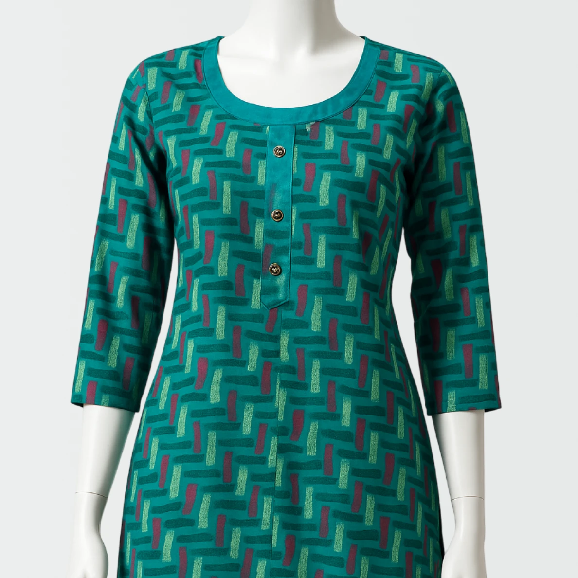 Green patterned dress on a mannequin against a white background