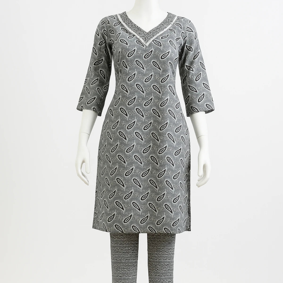 Gray patterned dress on a mannequin against a white background