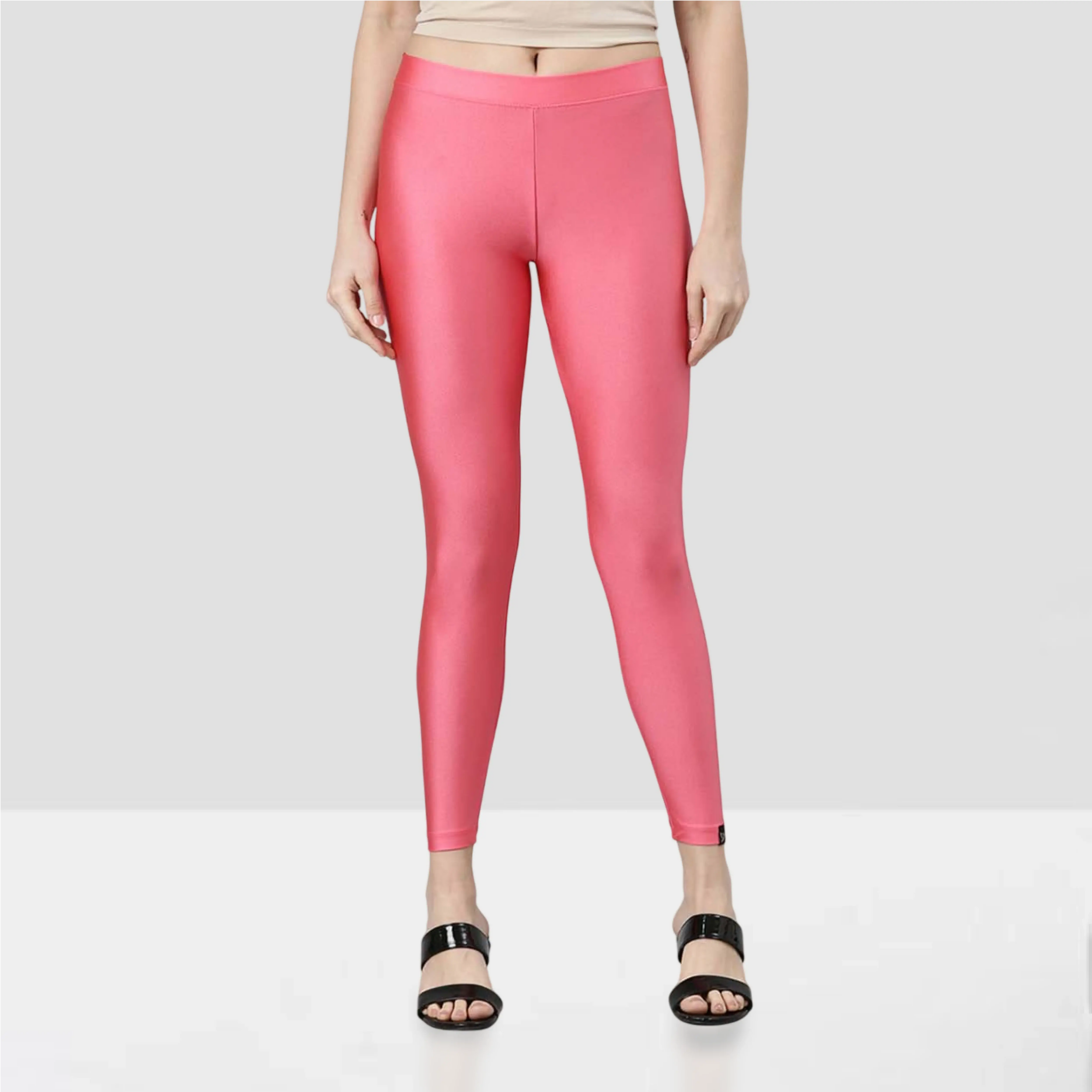 Person wearing bright pink leggings on a beige background
