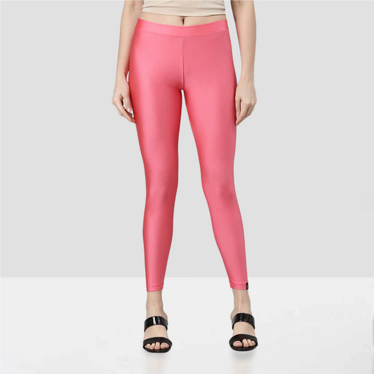 Person wearing bright pink leggings on a beige background