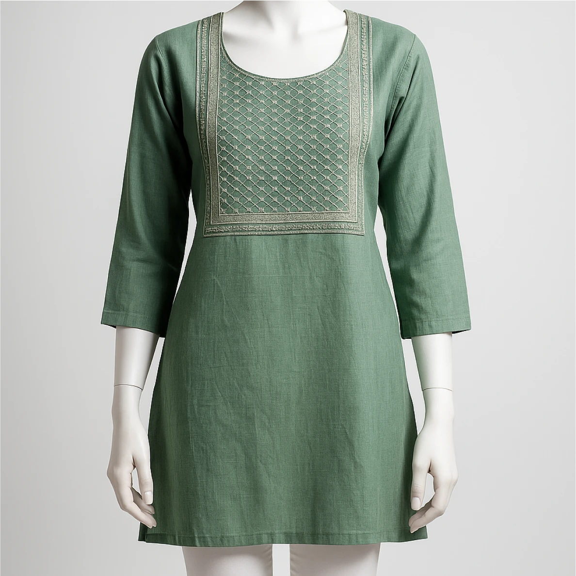 Green dress with embroidery on a mannequin against a white background