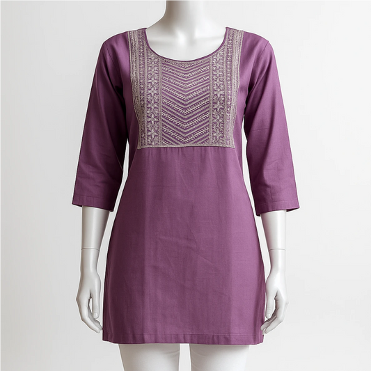 Purple dress with intricate embroidery on a mannequin against a white background
