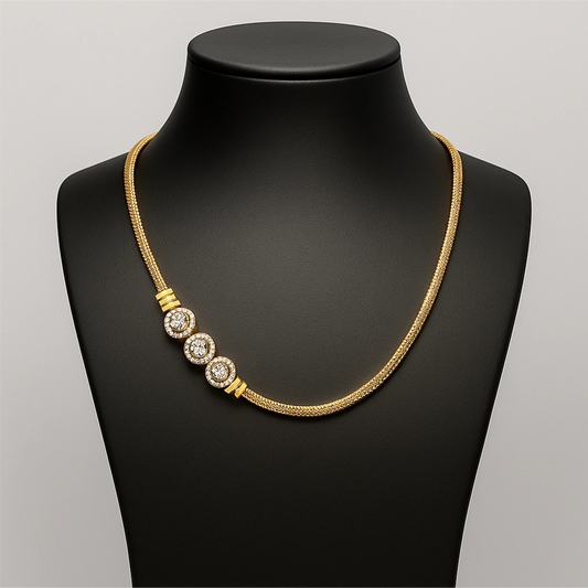Gold necklace with three circular pendants on a black mannequin bust.