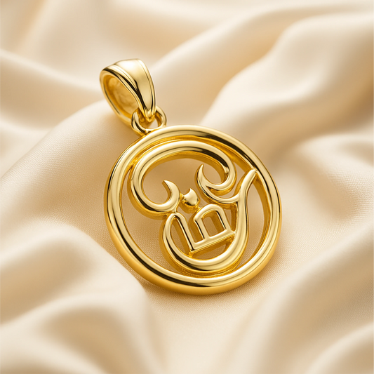 Gold pendant with intricate design on a beige fabric background