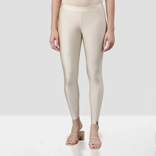 Beige leggings worn by a person on a white background