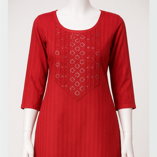 Red dress with intricate embroidery on a mannequin against a white background
