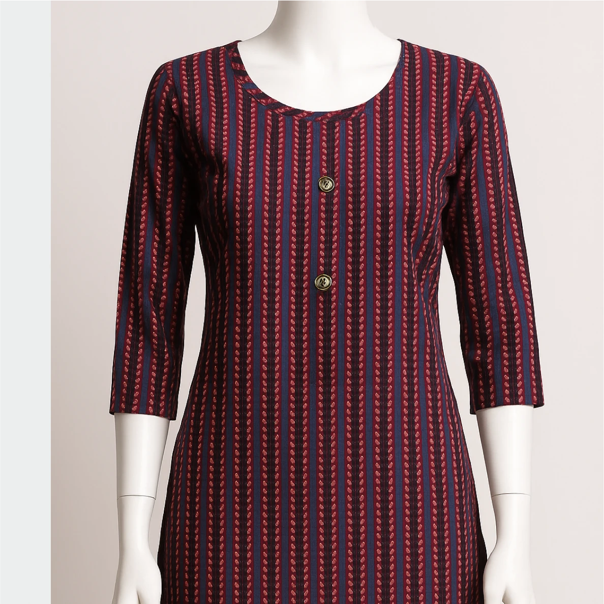 Red and blue patterned dress on a mannequin against a plain background