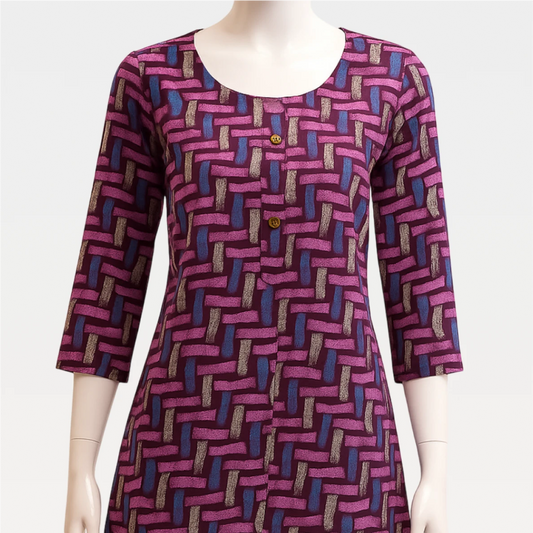 Mannequin wearing a patterned dress with a geometric design on a plain background