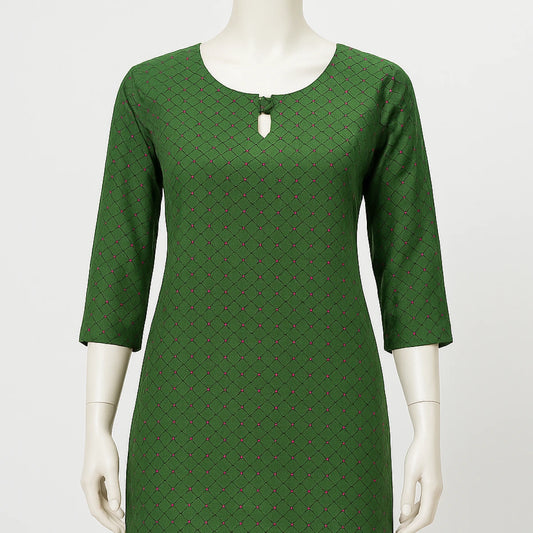 Green patterned dress on a mannequin against a white background