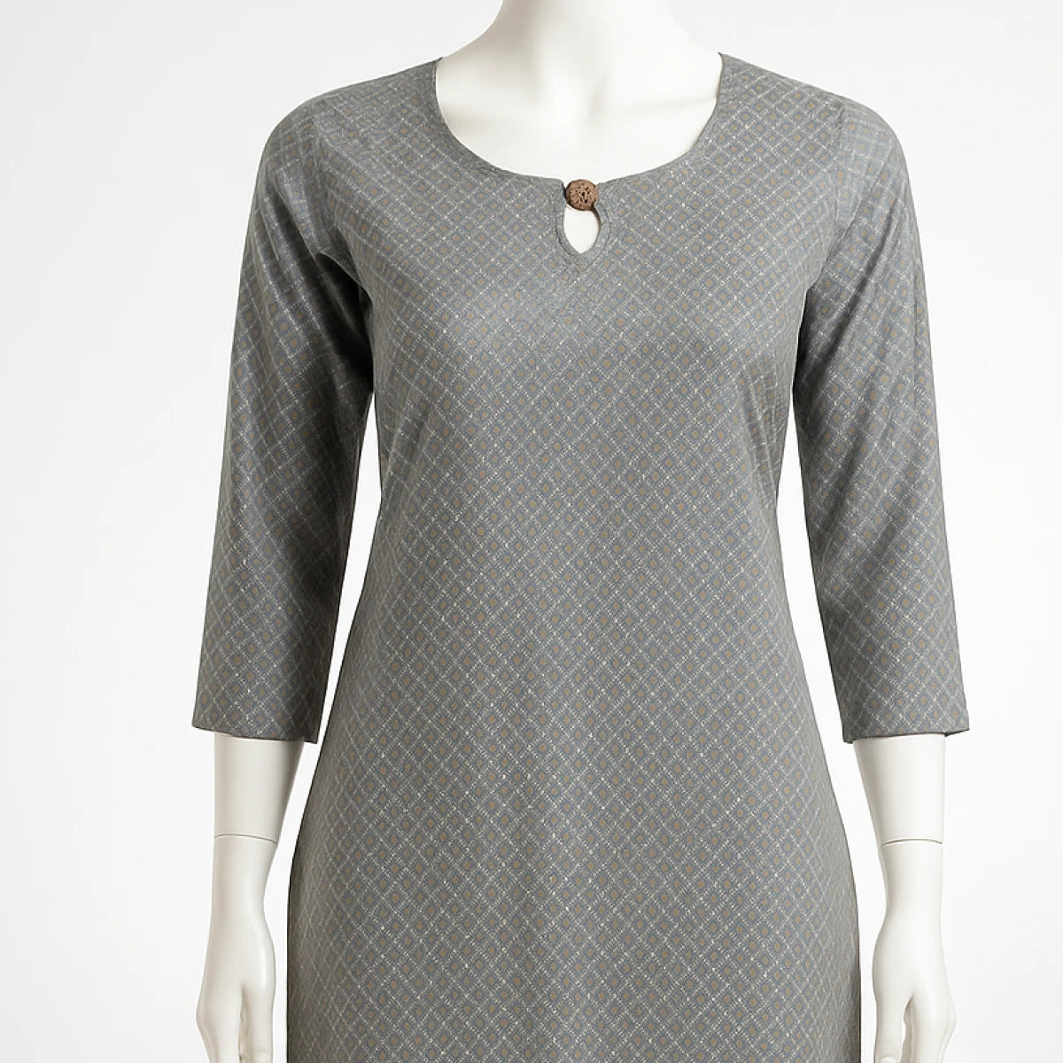 Gray patterned dress on a mannequin against a white background